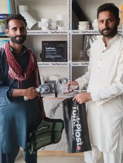 TurkPlast kit bags handed over in front of the shop's TurkPlast Authorized Dealer shelves